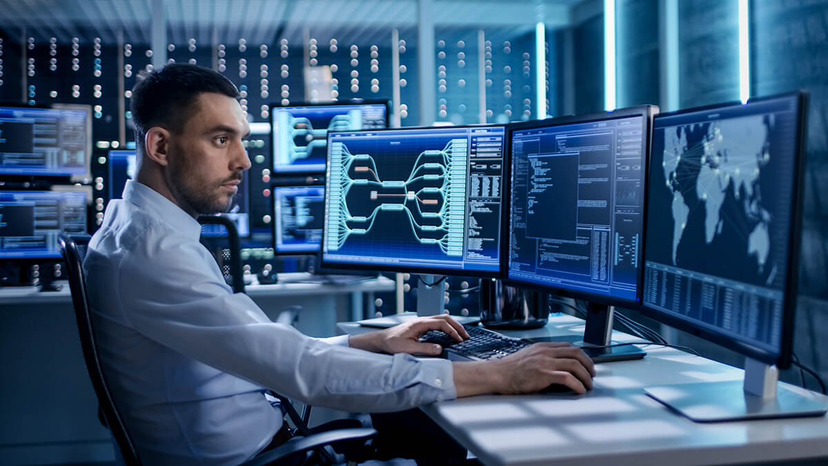 stock_image of man with multiple computer screens