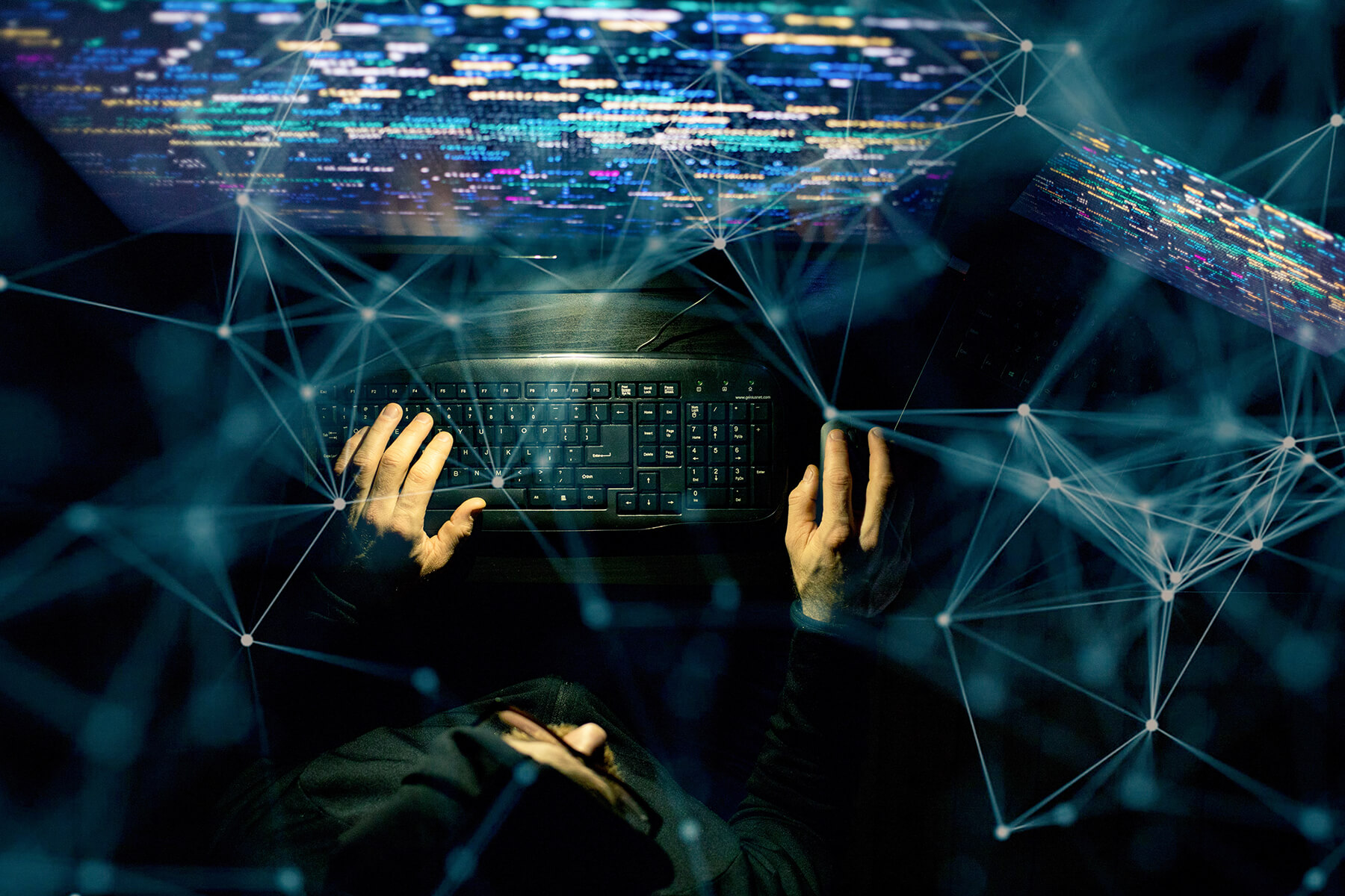image of man with multiple computer screens that represents UPI Cybersecurity services